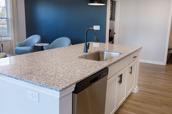 A kitchen with a sink and a counter.